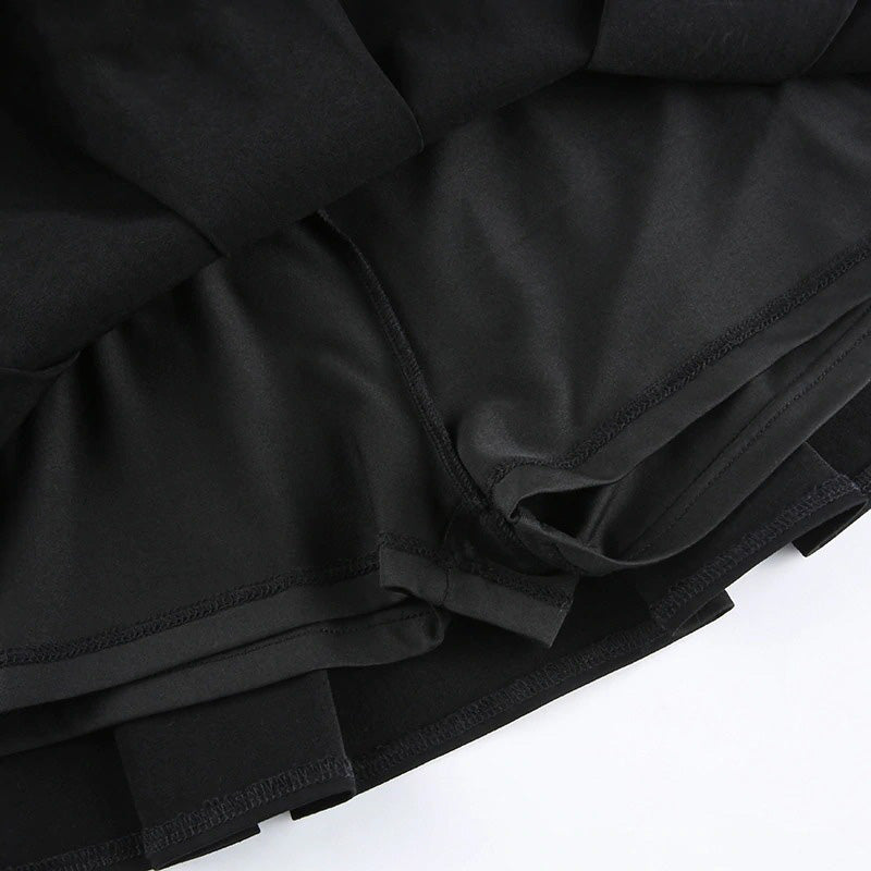 Close-up of the inside view of a black pleated gothic mini skirt showcasing its sleek fabric and stitching.