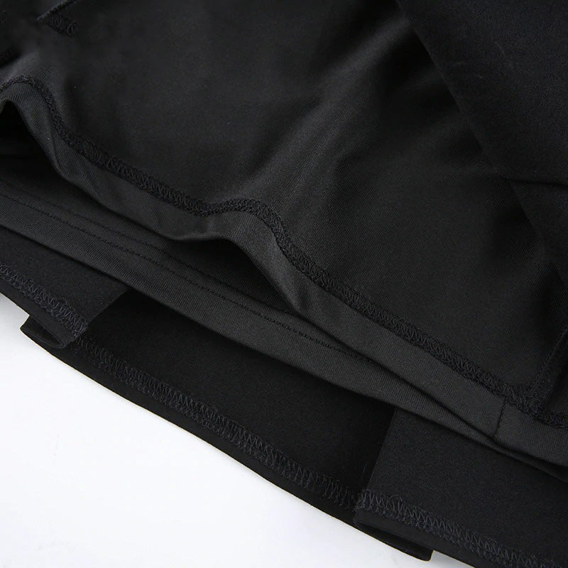 Close-up of the inside fabric of a sexy gothic black mini skirt, showcasing pleats and high waist design.