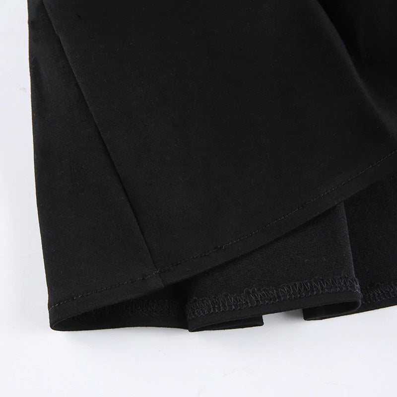 Close-up of a black pleated mini skirt hem, showcasing high-quality fabric and neat stitching details for gothic fashion.
