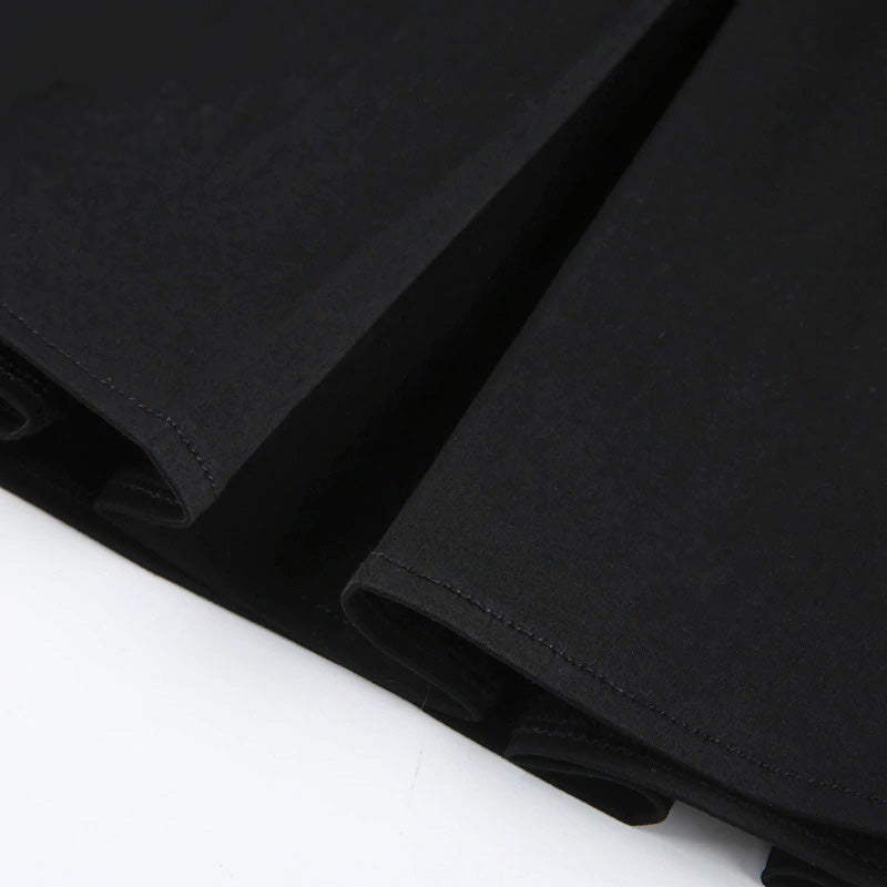 Close-up of a black pleated mini skirt showcasing the stylish, smooth fabric and detailed stitching.