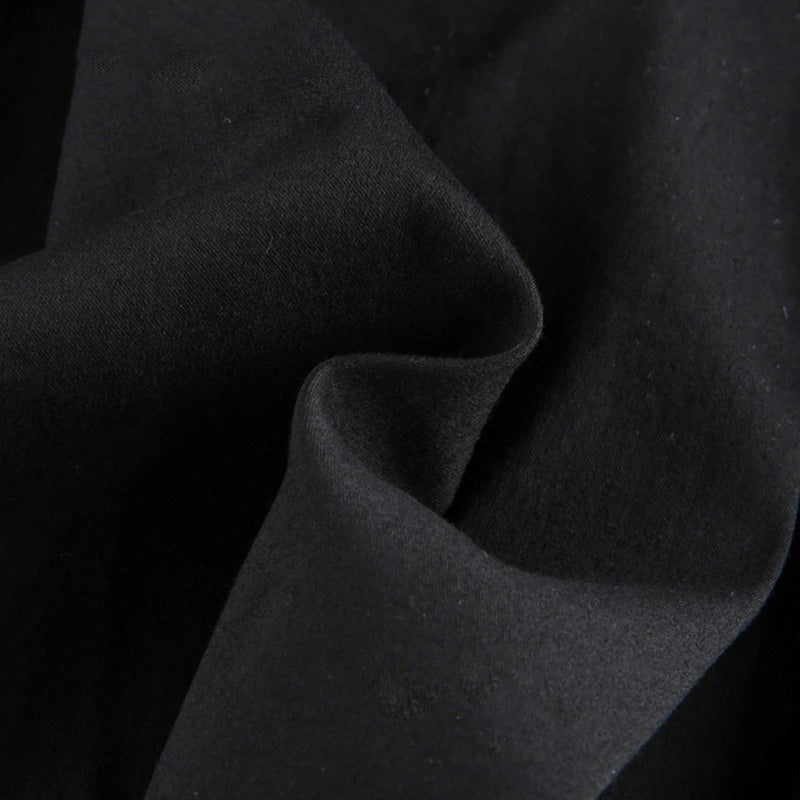 Close-up of soft, black fabric ideal for a gothic pleated mini skirt, showcasing its smooth texture and versatility.