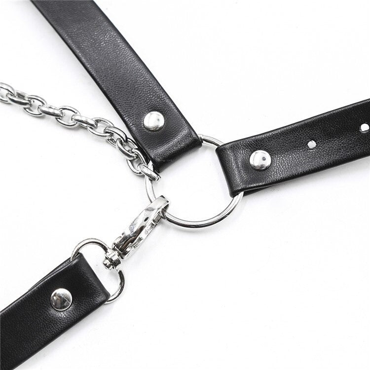 Close-up of a sexy gothic body harness featuring synthetic leather straps and chains, perfect for waist bondage fashion.