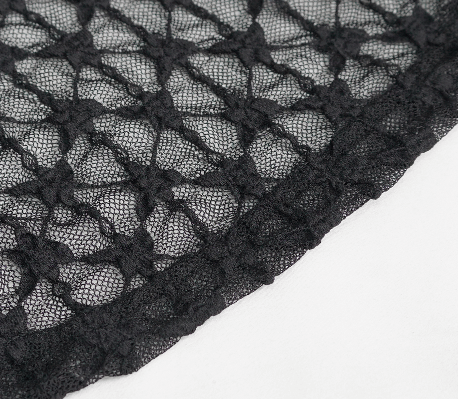 Close-up of black lace fabric with intricate pattern, perfect for gothic fashion and stylish outfits.