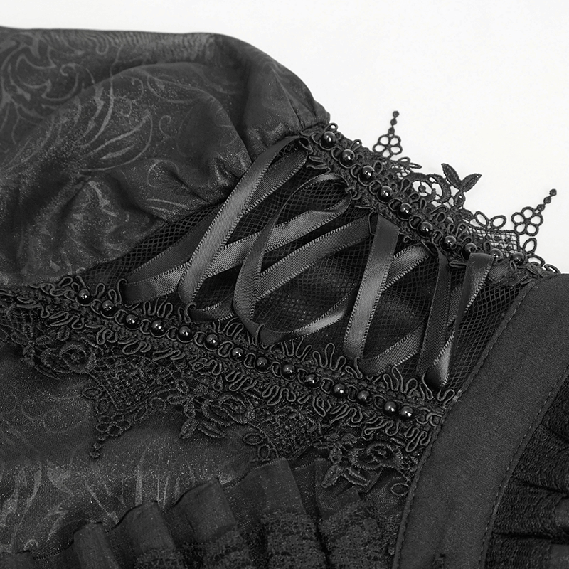 Close-up of black gothic blouse detailing with ruffles and lace-up accents for a stylish feminine look.