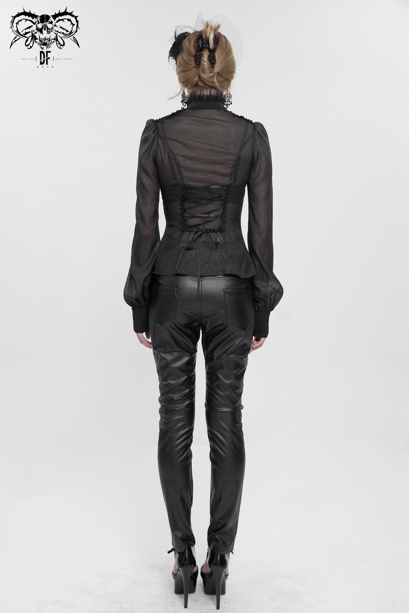 Back view of a sexy gothic black blouse with long sleeves and ruffled details, paired with sleek black pants.