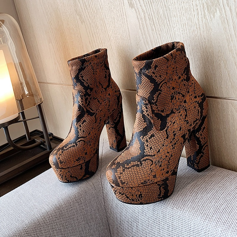 Fashionable women's pointed toe ankle boots with brown snake skin print and high platform heels.