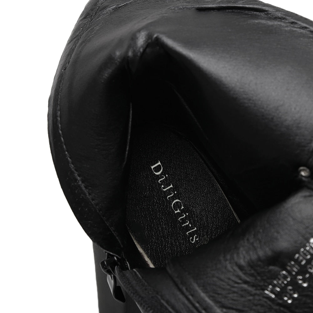 Inside view of stylish black platform ankle boots with laces and zipper, perfect for a rocker outfit.