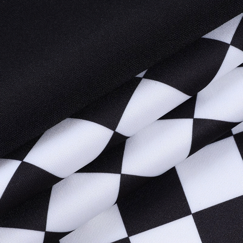 Close-up of black and white plaid fabric, perfect for a stylish high waist mini skirt in summer streetwear.