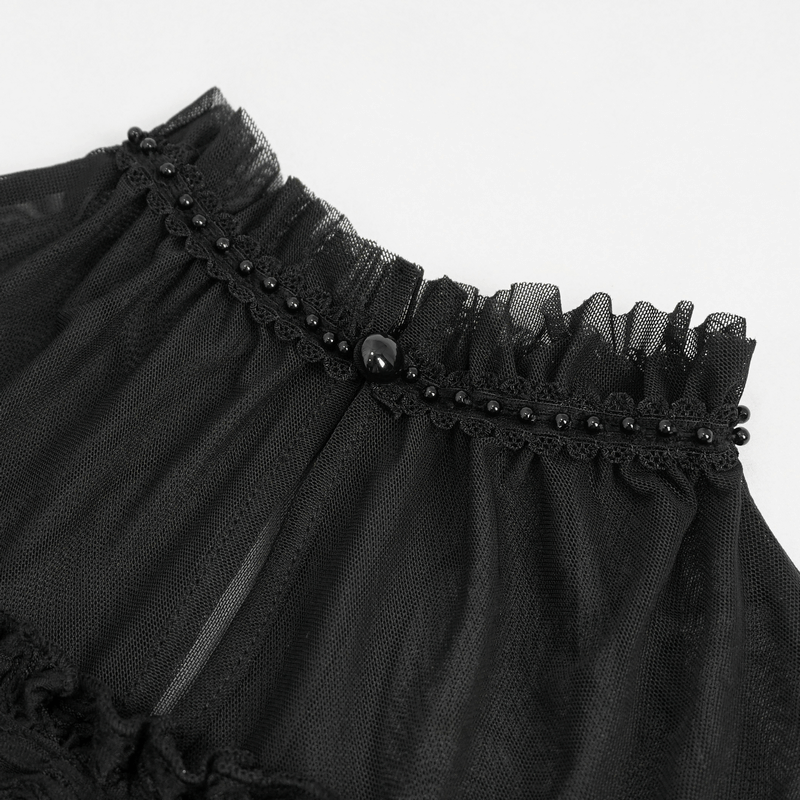 Close-up of elegant black lace detail with ruffle and bead embellishments for gothic fashion.