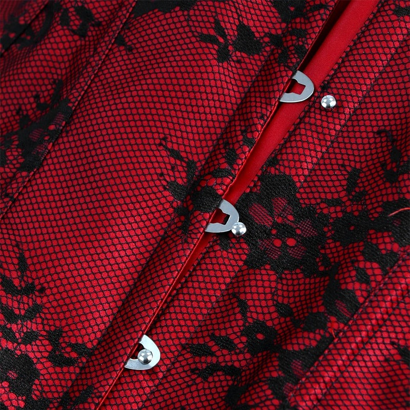 Close-up of red lace corset with black floral design and silver clasps, showcasing gothic elegance.