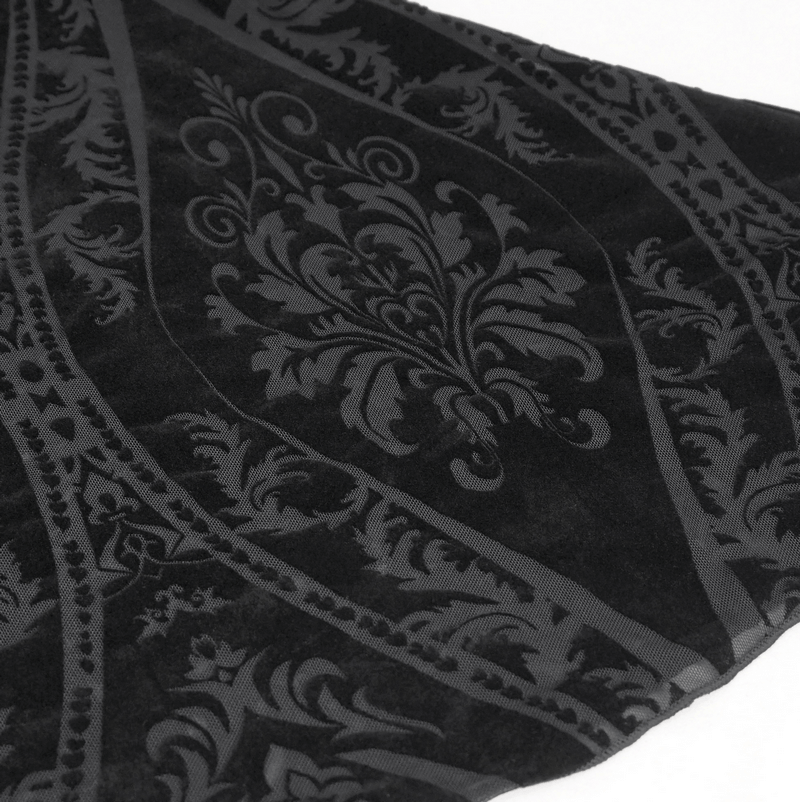 Close-up of intricate gothic pattern on black flared pants, showcasing stylish design and texture.