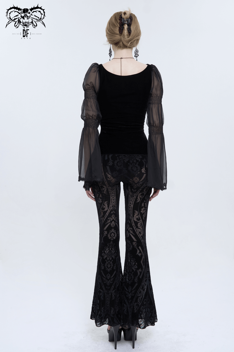 Back view of woman in stylish gothic black flare pants and sheer sleeve top, showcasing trendy pattern and silhouette.