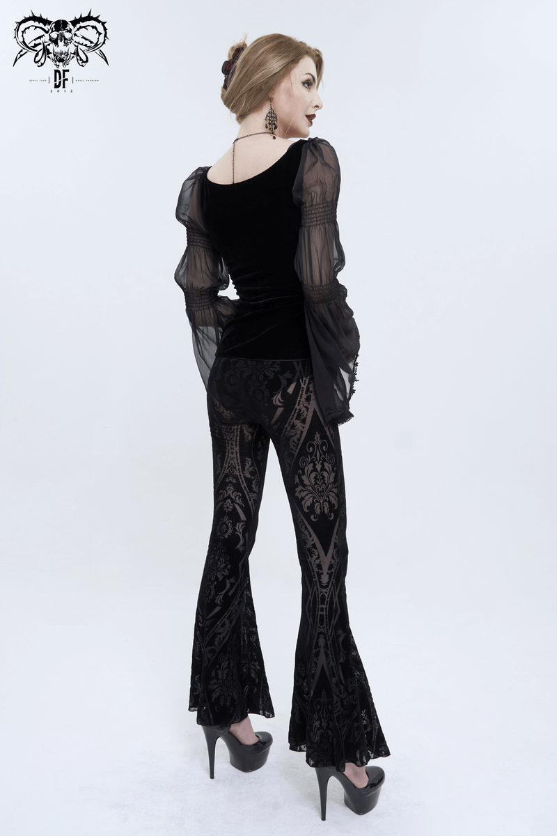 Woman in stylish black gothic flared pants with intricate pattern, showcasing a chic gothic fashion look.