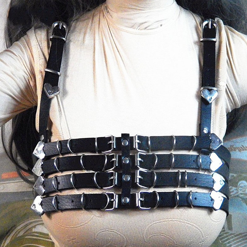 Stylish PU leather harness bra with heart-shaped metal accents, perfect for daring alternative fashion enthusiasts.