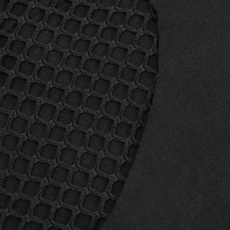 Close-up of black transparent fabric with a netted lace design, perfect for a gothic outfit.