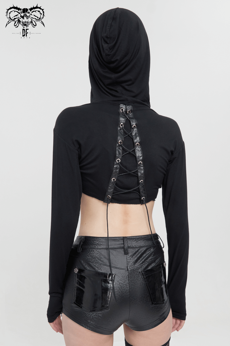 Back view of a sexy black gothic top with lace-up design, worn with shiny black shorts, showcasing a stylish edgy look.