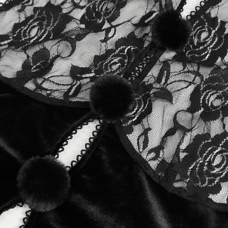 Close-up of a black lace bodysuit with floral patterns and soft pom-poms, showcasing gothic elegance and luxurious velvet.