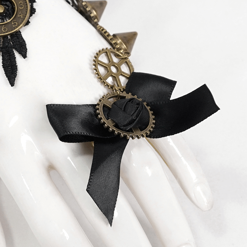 Elegant black bow with gear detail on a hand mannequin, perfect for gothic feather gloves accessory.