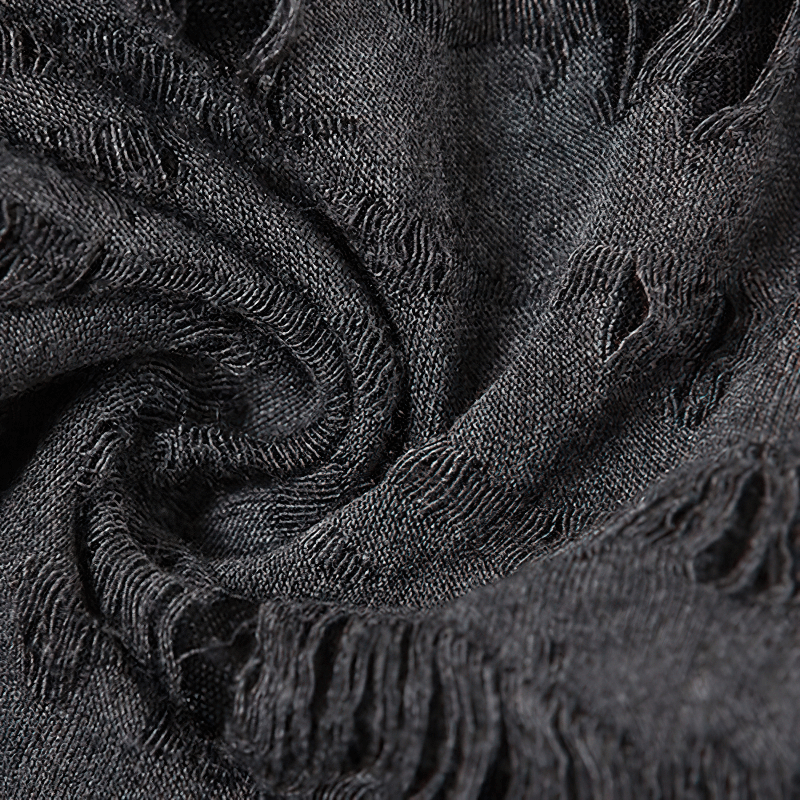 Close-up of soft, textured black fabric featuring stylish frayed edges, perfect for trendy casual wear.