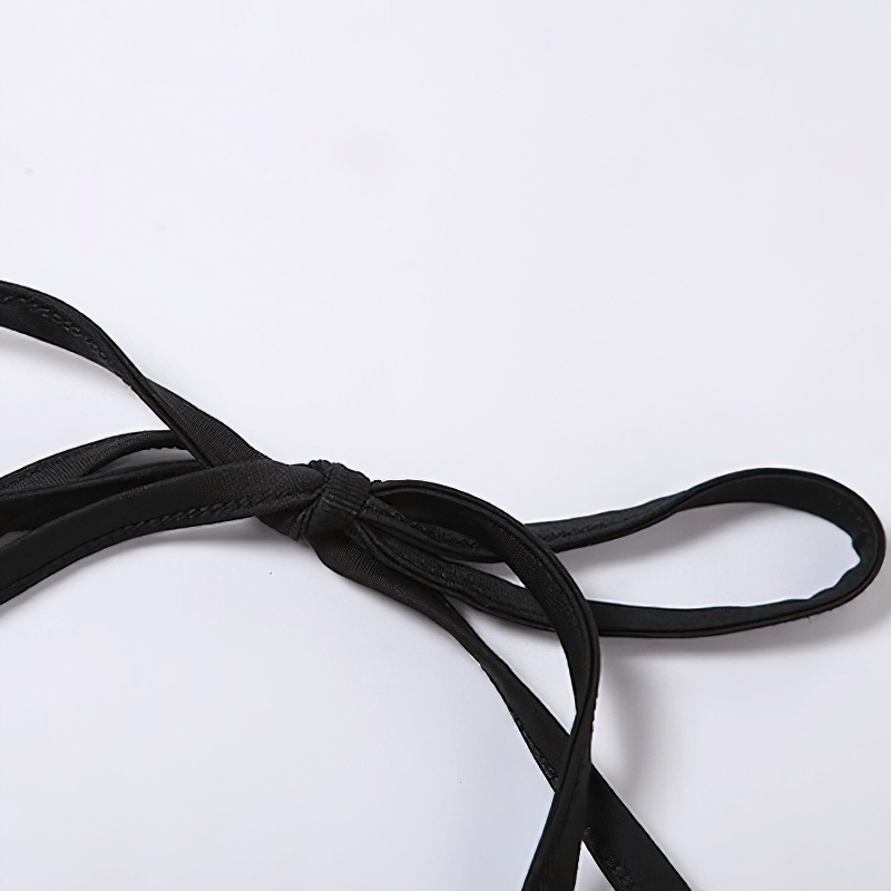 Close-up of a black fabric tie, showcasing a stylish and chic accessory for fashion enthusiasts.