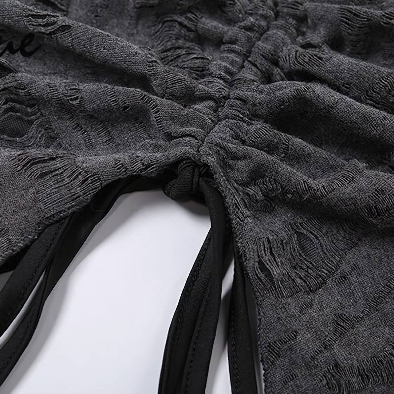 Close-up view of a stylish gray top showing the ruched fabric and open shoulder design for women.