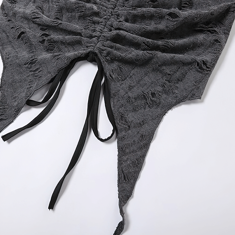 Close-up of a stylish gray crop top featuring open shoulders and decorative ties for a trendy look.