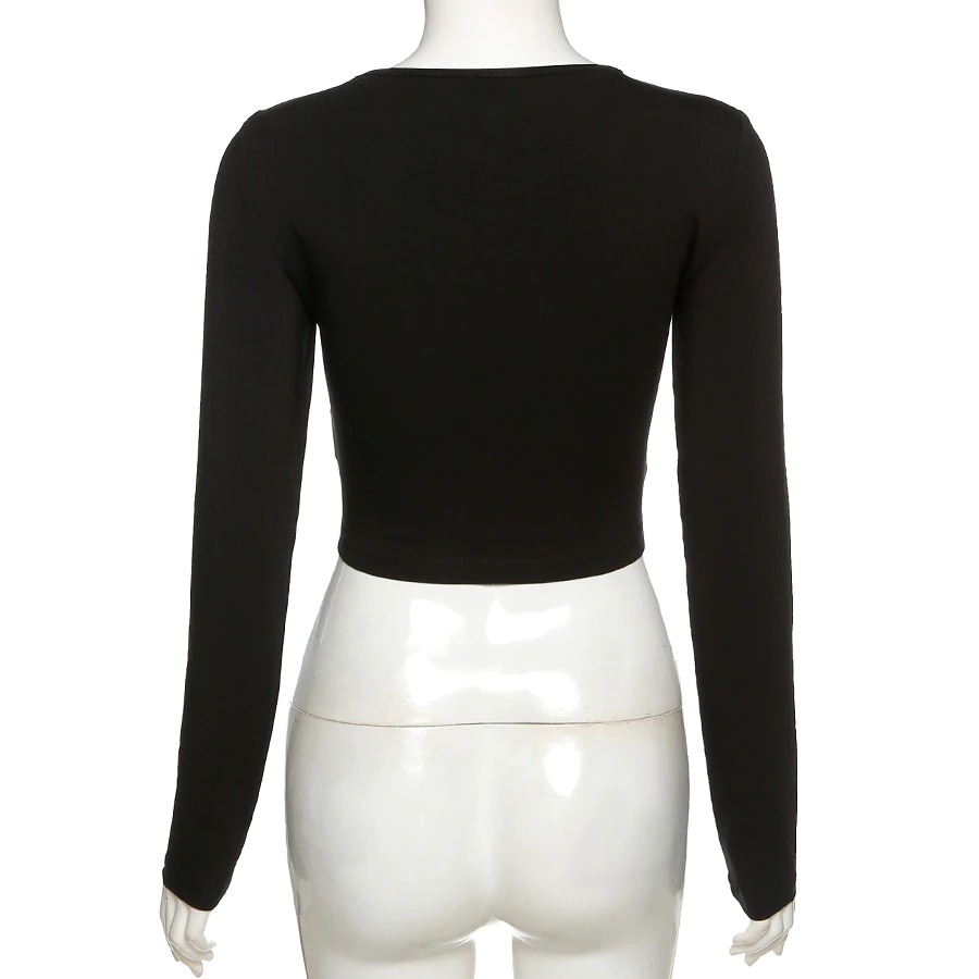 Back view of a black gothic long sleeve crop top with a skew collar, showcasing a stylish and edgy fashion design.