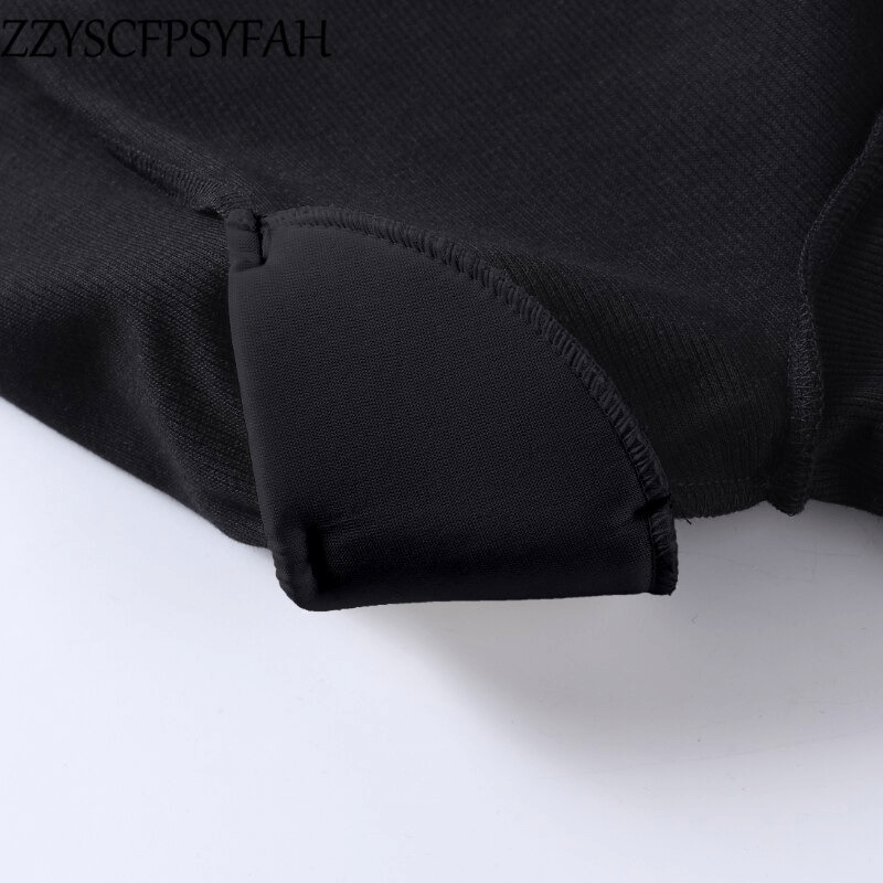 Close-up of the off-shoulder seam on a sexy women's black ribbed bodysuit, showcasing quality material and aesthetic design.