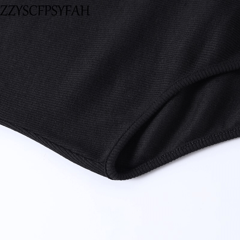 Close-up of a black ribbed fabric from a sexy women's off-shoulder bodysuit, showcasing quality material.