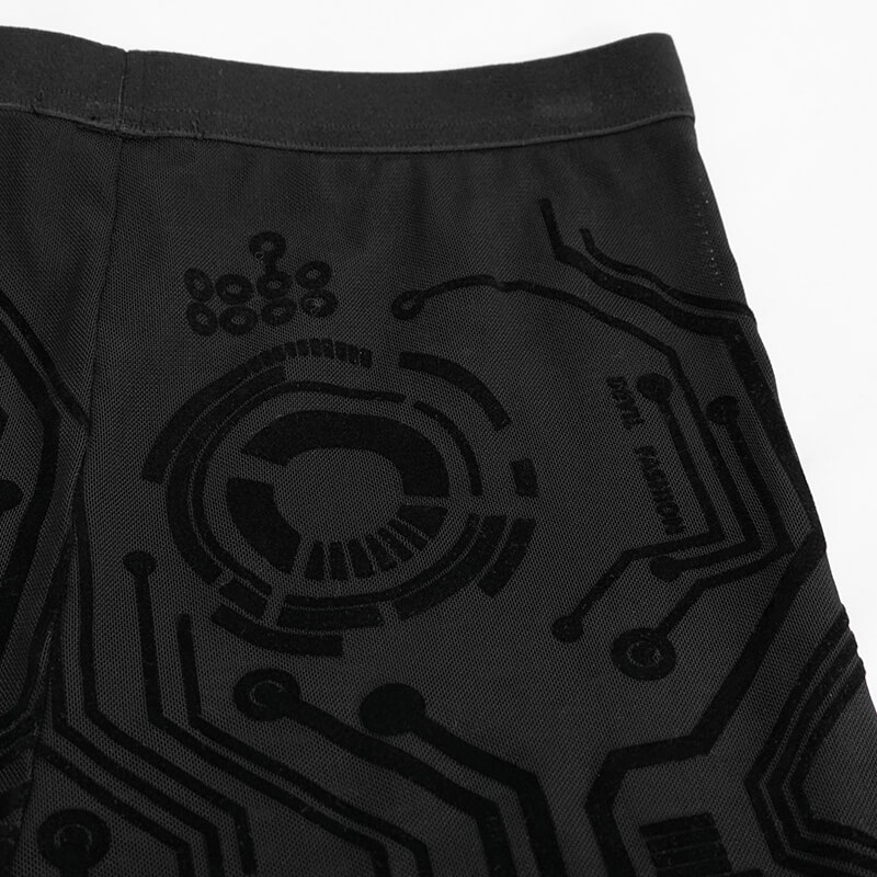 Close-up of cyberpunk style black leggings featuring circuit-like print design.