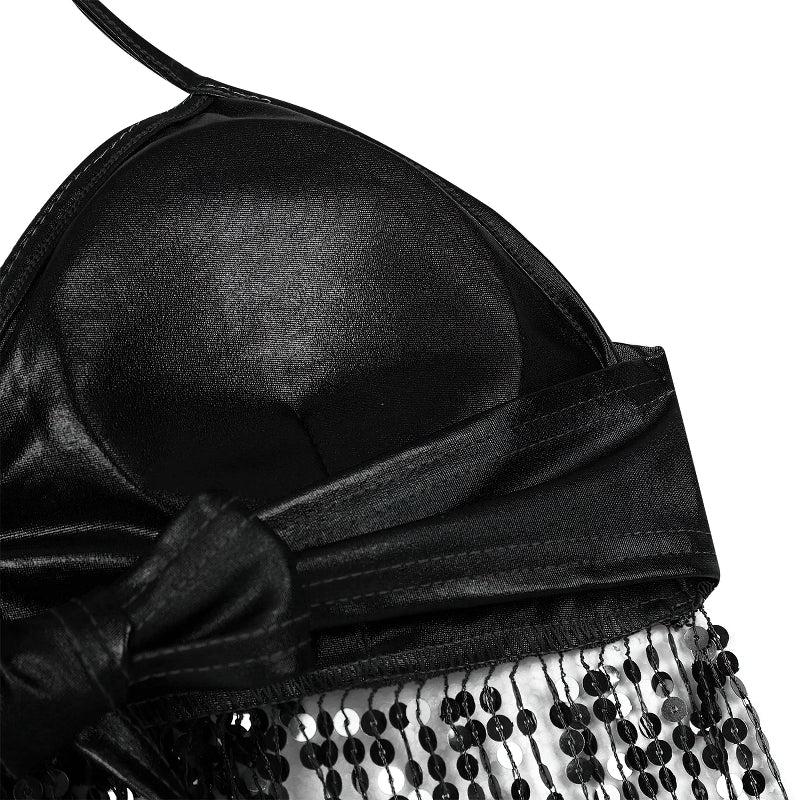 Close-up of a sexy women's shiny bra top with black sequins and bow detailing for stylish performances.