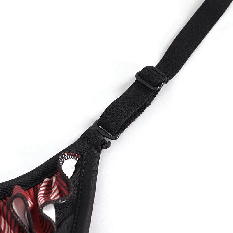 Close-up of black and red plaid bikini top strap with skull detailing, showcasing grunge swimwear style.