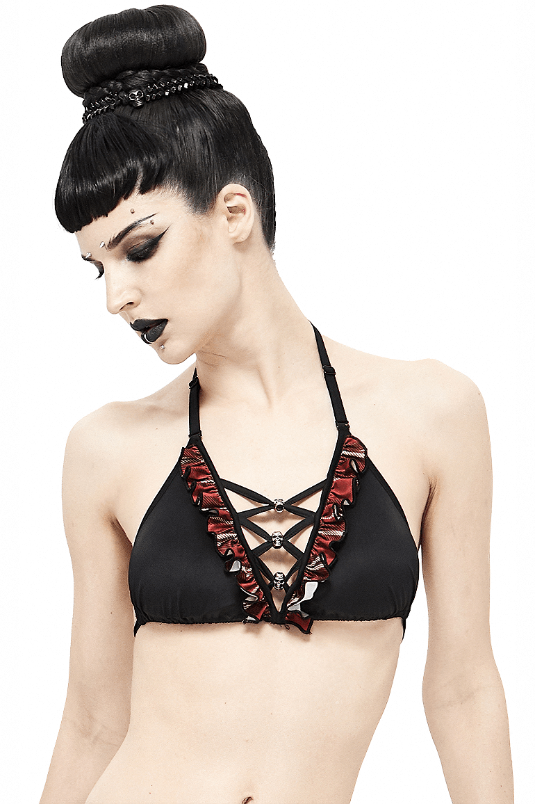 Sexy women's black and red plaid bikini top showcasing grunge style with skull pendants and trendy lace-up design.