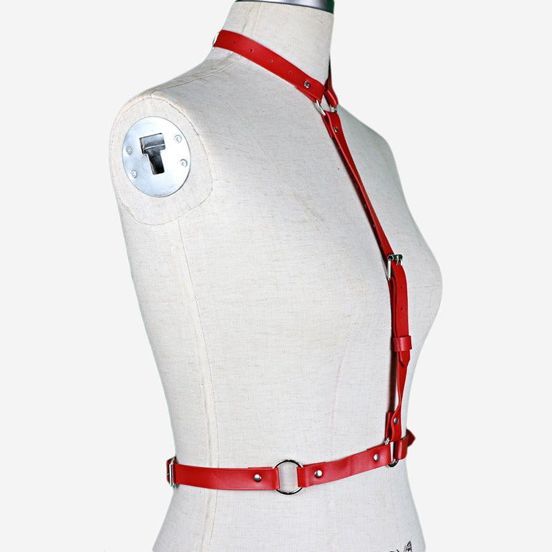 Red women's leather body harness, perfect for gothic and alternative fashion styles, featuring durable synthetic leather and metal rings.