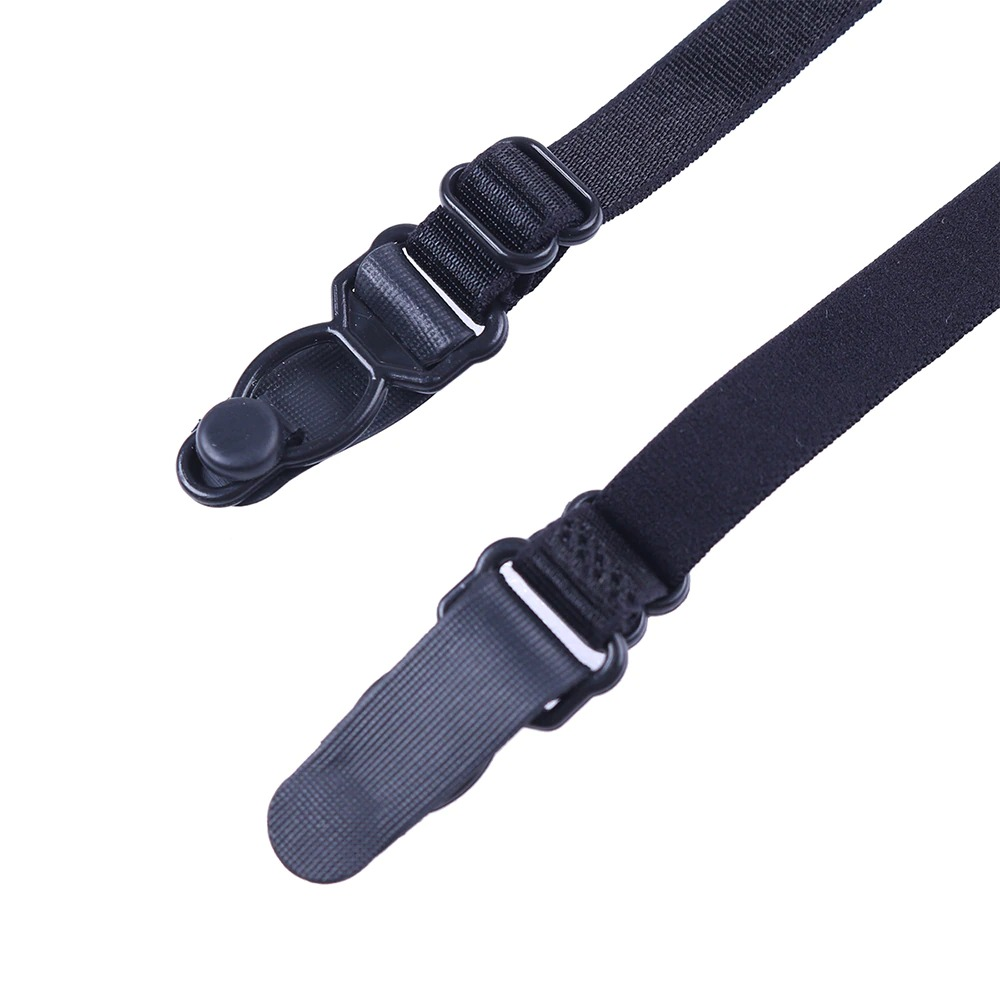 Close-up of black suspender clips and straps, designed for women's high-waisted panty garments.