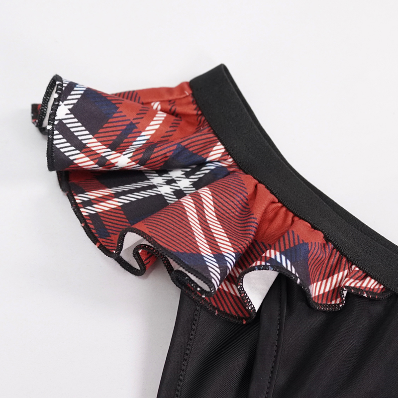 Close-up of Scottish check ruffles on sexy women's swimming trunks in grunge style.