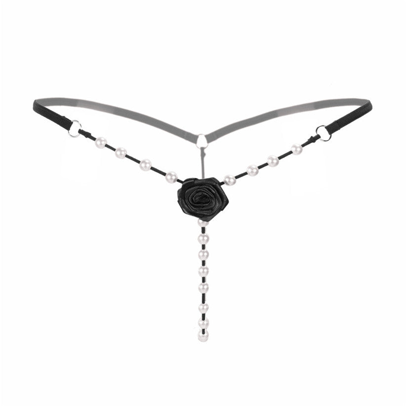 Attractive women's G-string thong with beads and a rose flower, perfect for a chic intimate outfit.