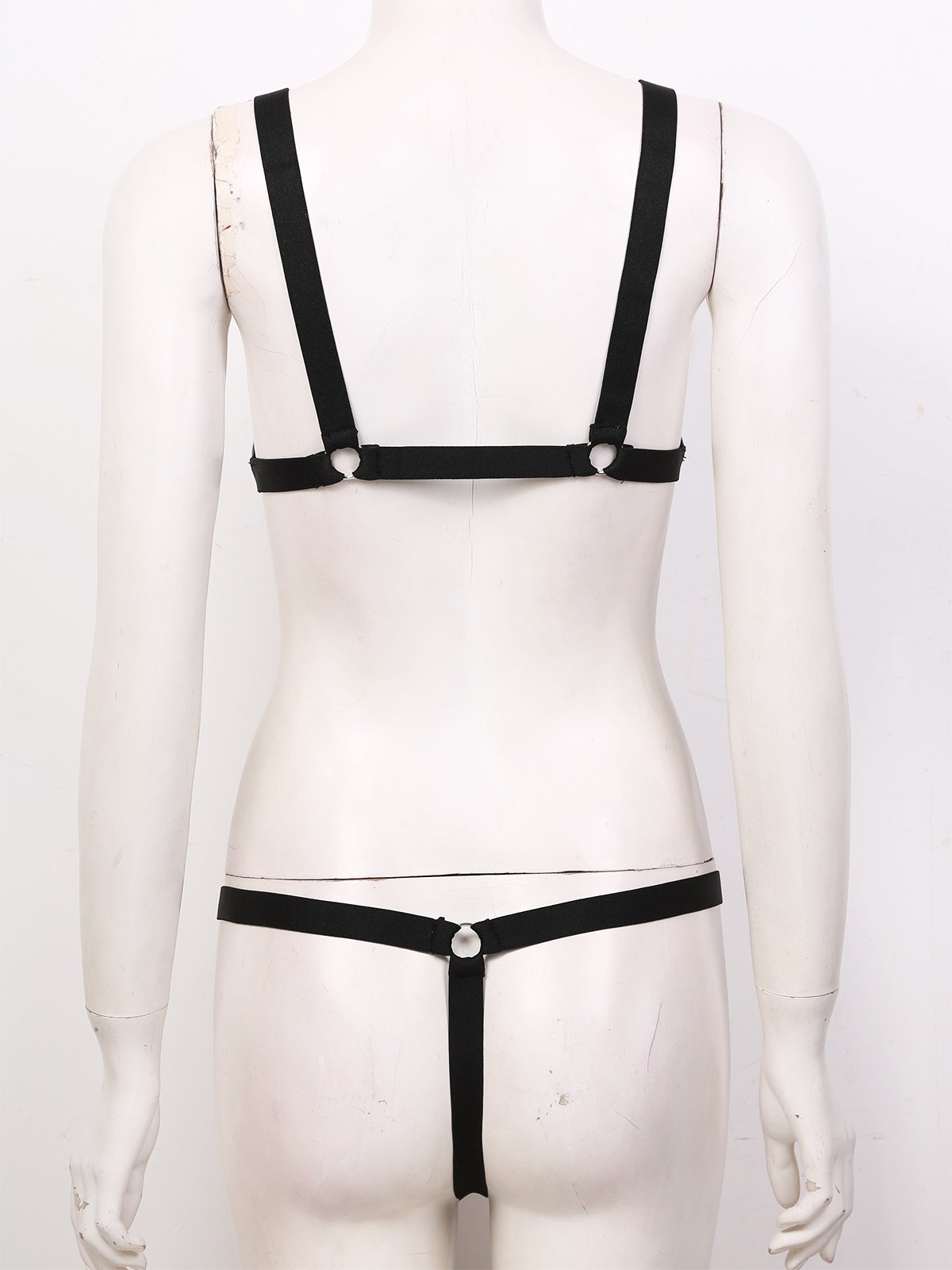 Back view of sexy women's gothic lingerie set featuring elastic straps and mini g-string design.