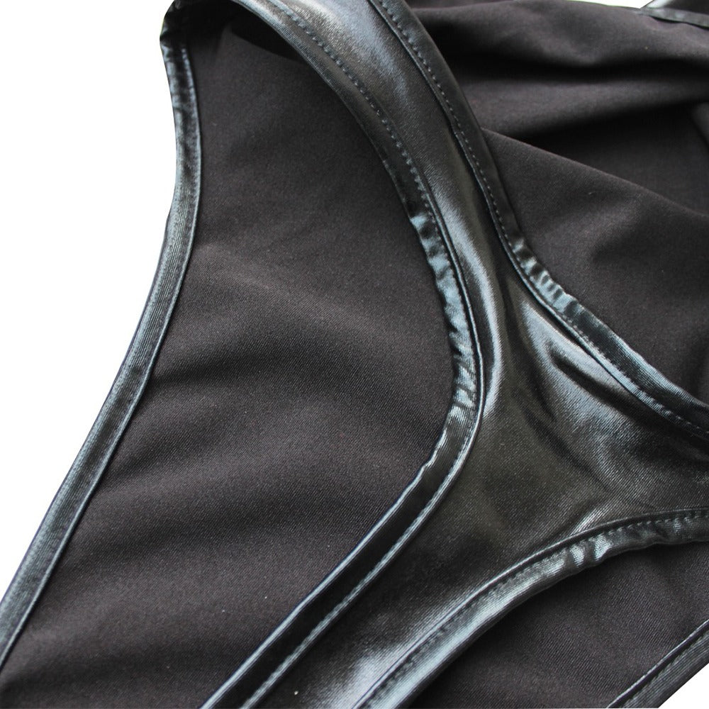 Close-up of shiny black latex women's bodysuit highlighting its sleek design and detailing.