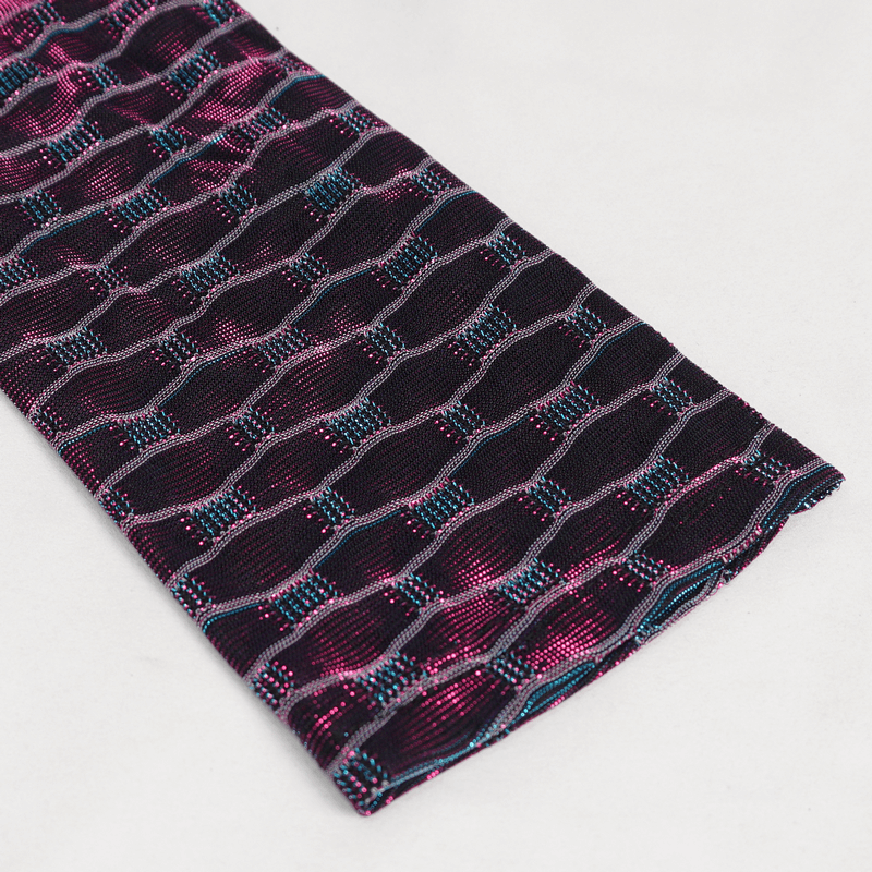 Close-up of stylish fabric with pink and teal patterns for punk dress detailing.
