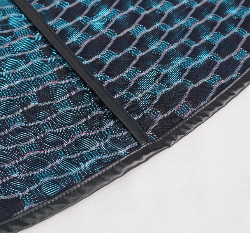 Close-up of unique mesh fabric in black and teal, showcasing modern punk style texture.
