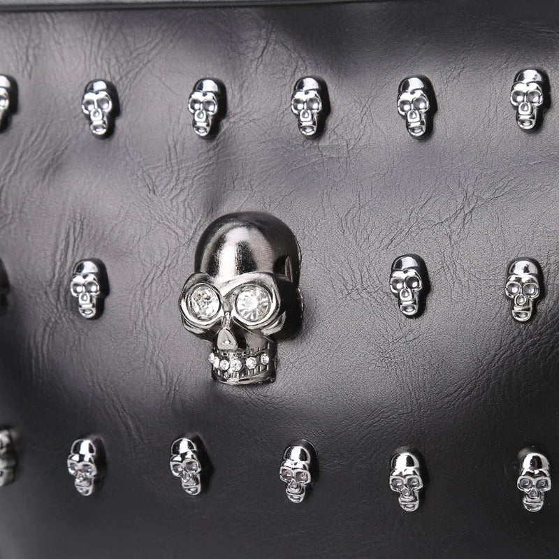 Close-up of black shoulder bag with shiny skull embellishments, perfect for rock style fashion.