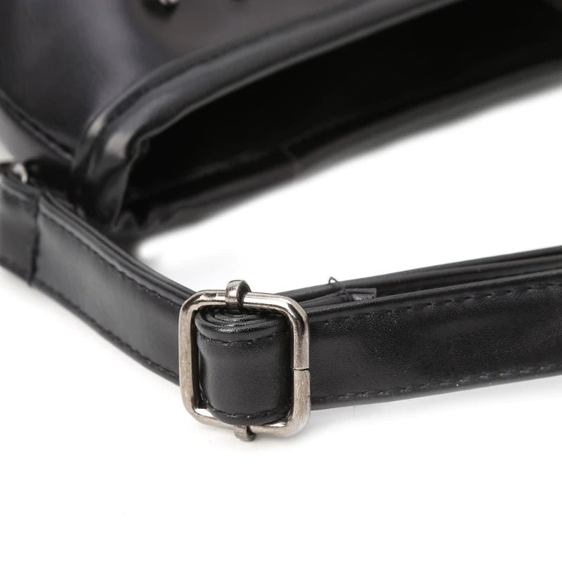 Close-up of the metal buckle on a black rock-style shoulder bag, showcasing its edgy design and quality materials.
