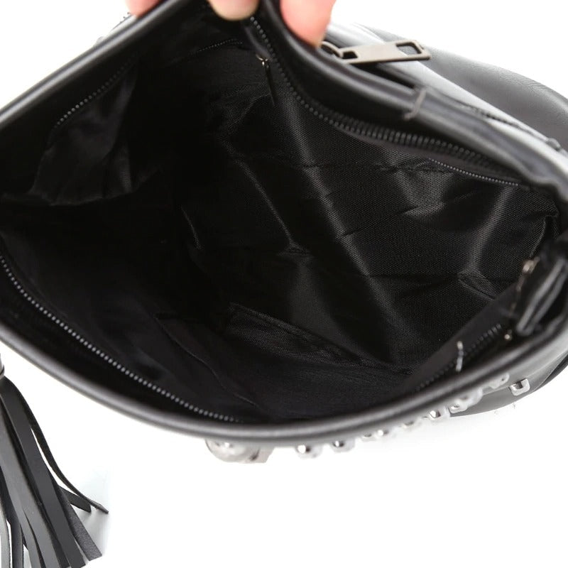 Interior view of a stylish women's rock skull shoulder bag showcasing black lining and zipper detail.