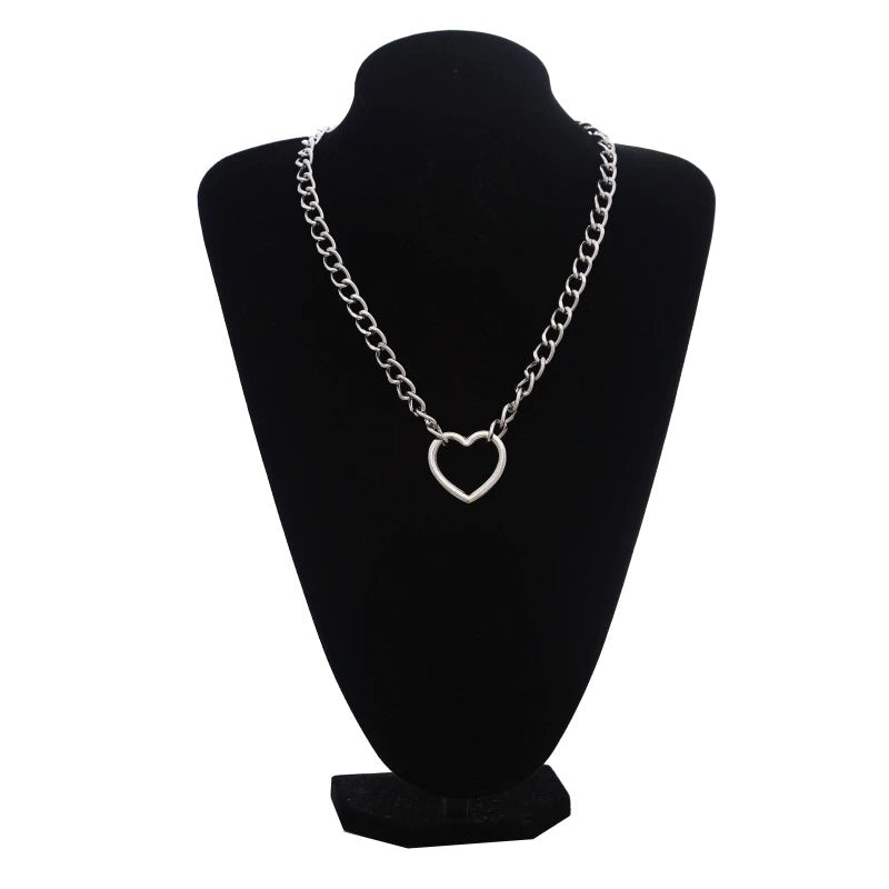 Silver color chain necklace with gothic heart shape pendant displayed on a black stand.