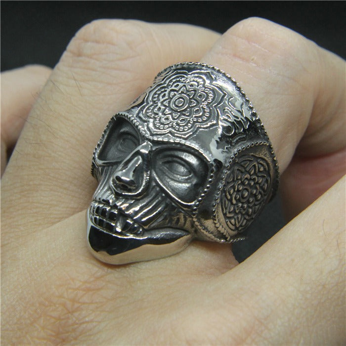 Heavy silver skull ring with intricate mandala designs, perfect for bikers and alternative fashion lovers.