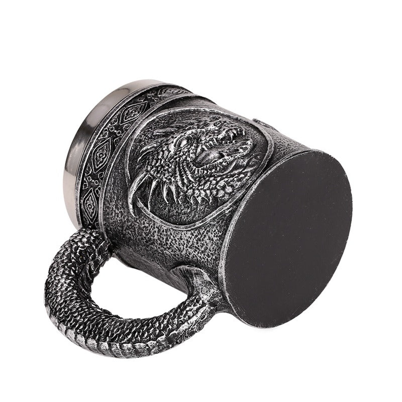 Vintage silver resin and stainless steel beer mug with dragon design, perfect for retro Viking pub style.