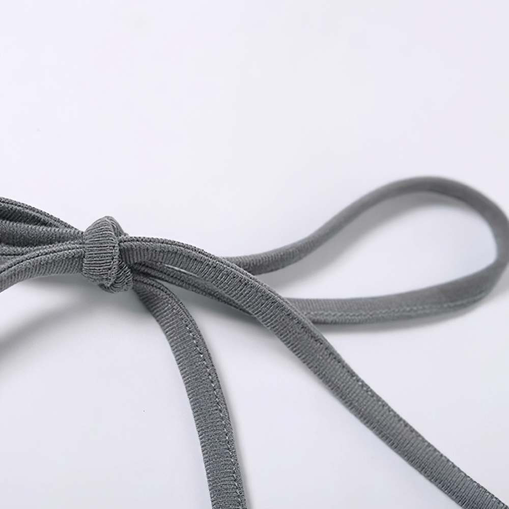 Close-up of a stylish gray camisole strap tied in a bow, showcasing quality fabric and trendy design.