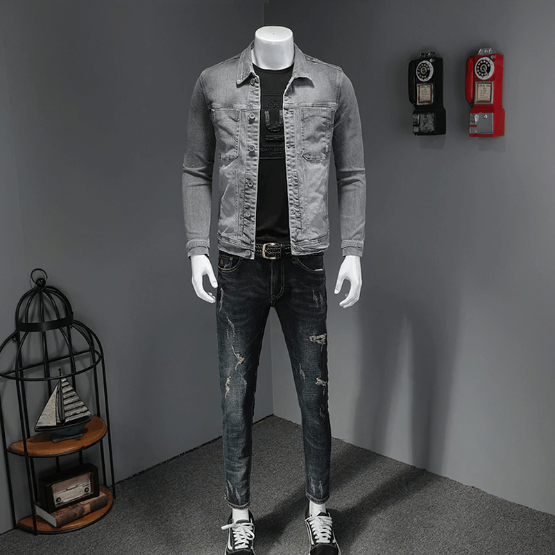 Men's slim fit gray denim jacket with turndown collar, paired with distressed jeans and stylish shoes in a trendy outfit.