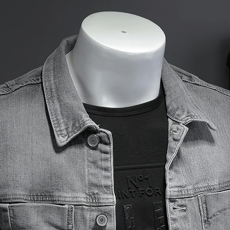 Men's gray slim fit denim jacket with turndown collar on display.
